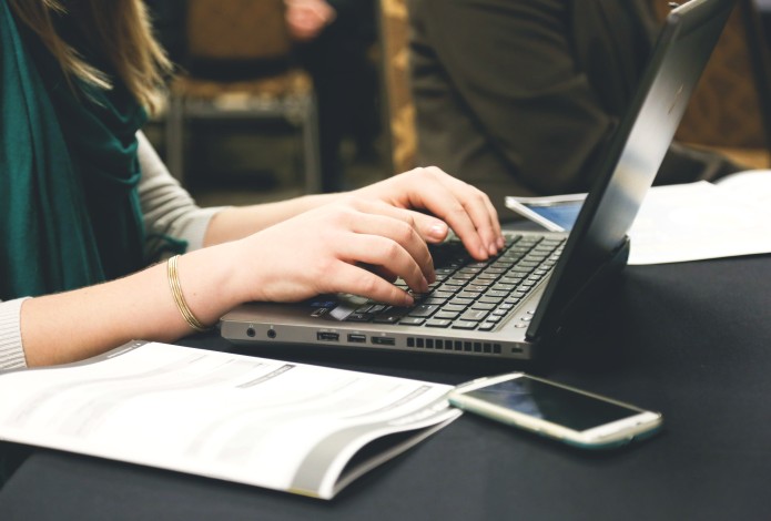 Woman typing on a computer